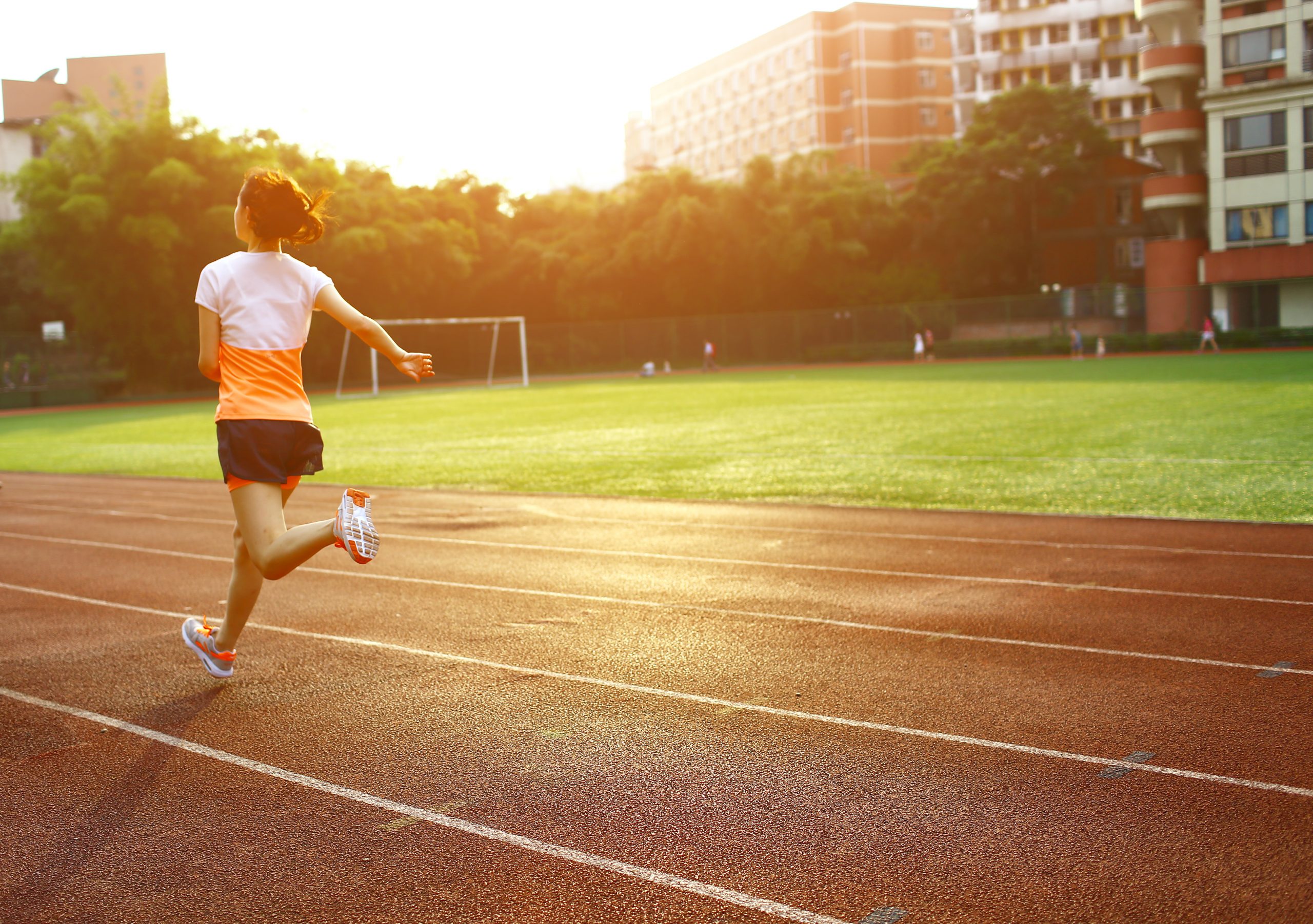 Athletic woman running on track